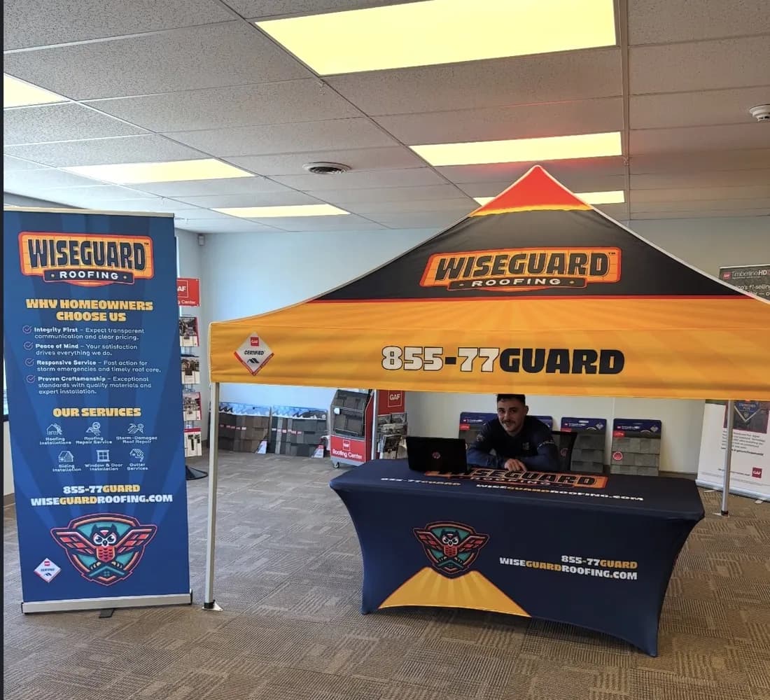Wiseguard Roofing canopy tent, roll-up banner and fitted table cover in a showroom