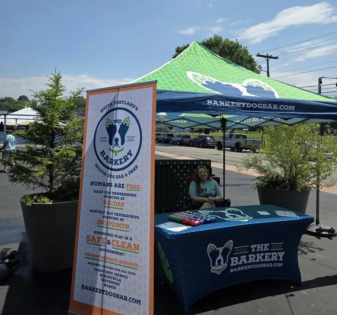 The Barkery canopy tent, roll-up banner and fitted table cover at an outdoor event