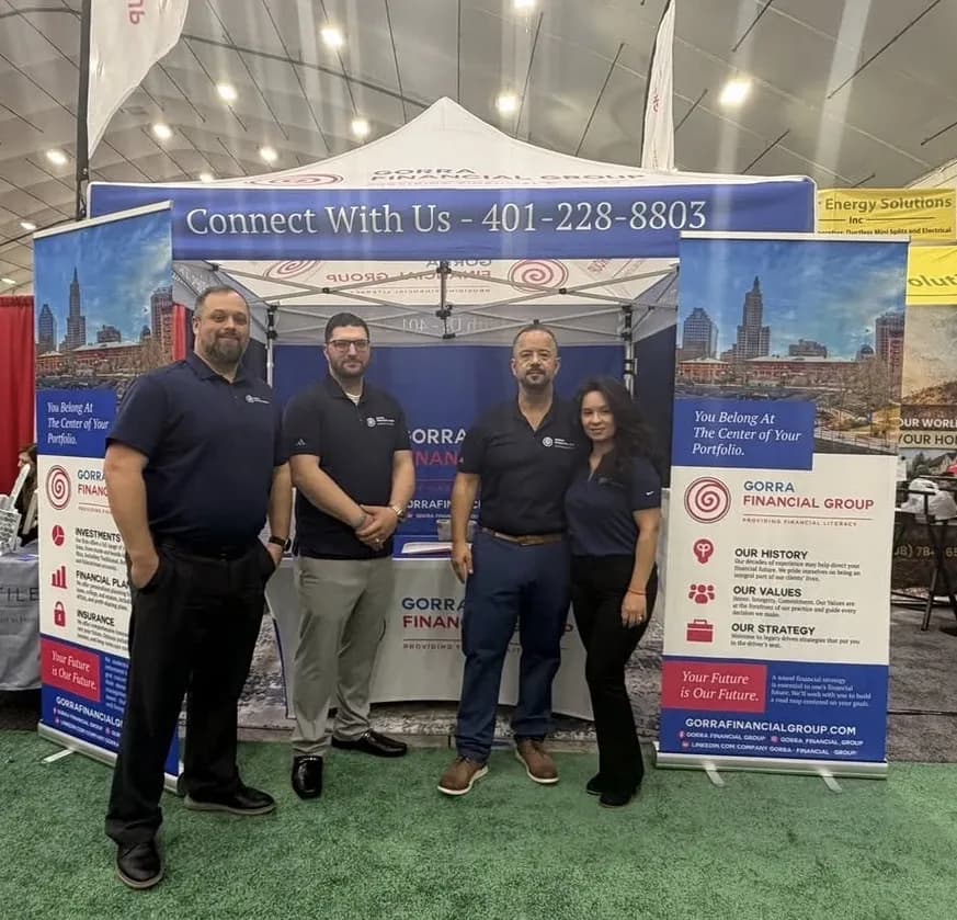 Gorra Financial Group team in front of their canopy tent and roll-up banners at an expo