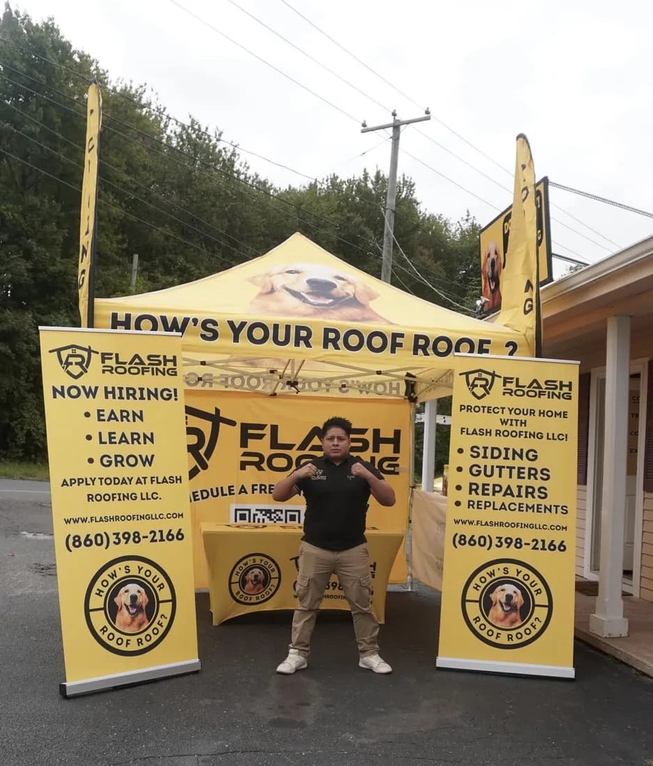 Flash Roofing canopy tent with roll-up banners, feather flags and a table cover outside their office